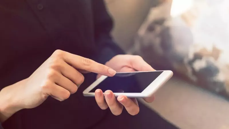 pessoa utilizando um celular enquanto usa handicap do basquete