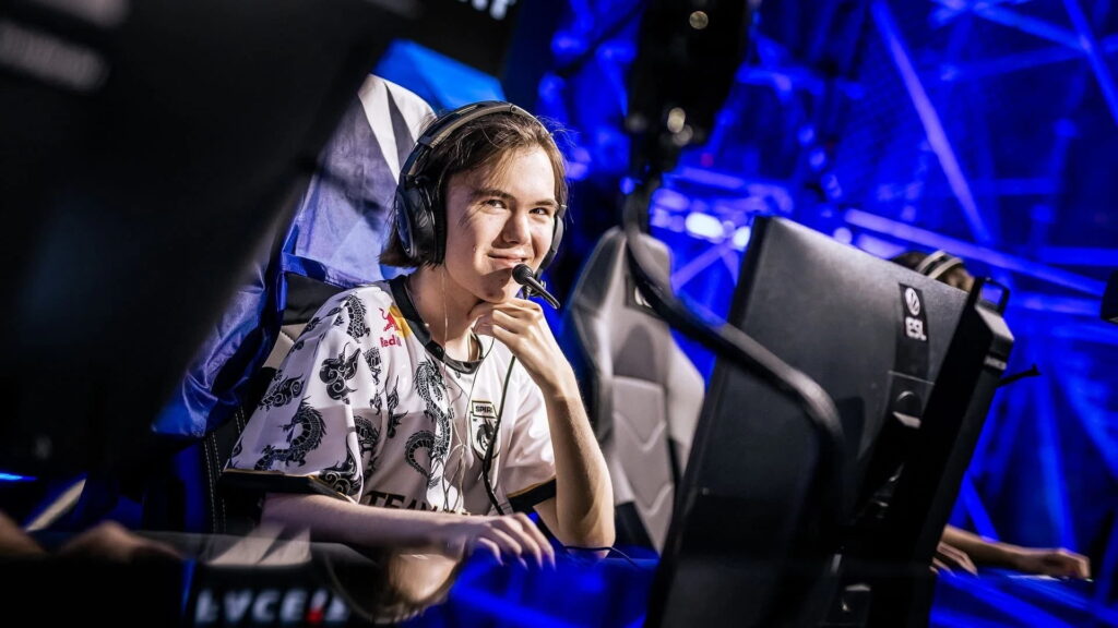 Counter-Strike 2 player donk wearing a headset and smiling during a live match