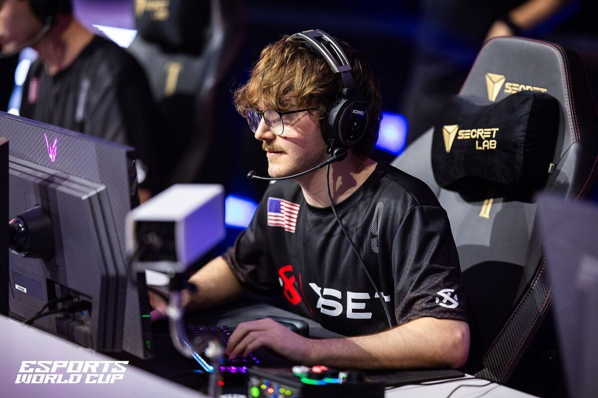 Ritual playing Fortnite on stage with headset and keyboard