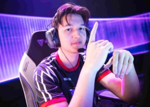 Pro player Leo Jannesson wearing a headset and pointing upward during a match.
