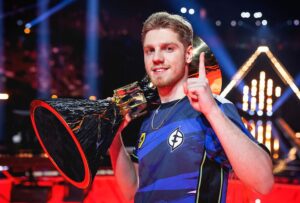 Demon1 holding the Champions 2023 trophy.