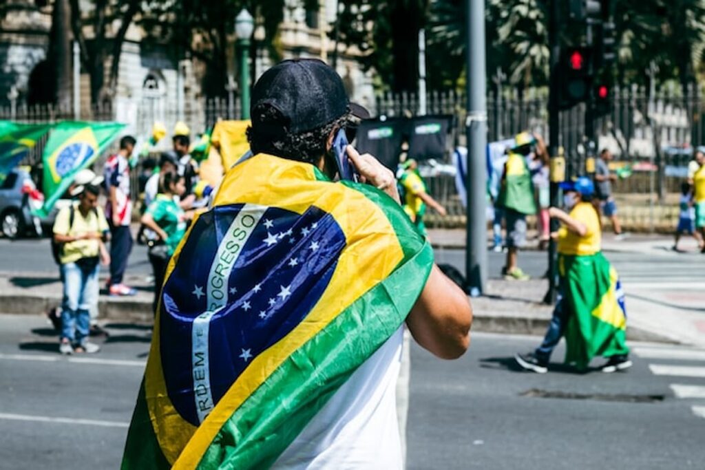 Brazilian walking around with Brazil flag on his back