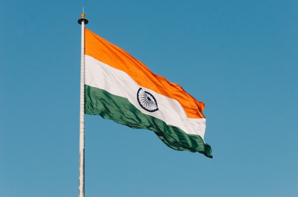 India flag flying with blue sky background.