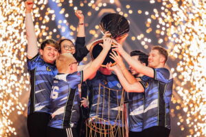 Evil Geniuses players lifting the VALORANT Champions trophy with fireworks in the background