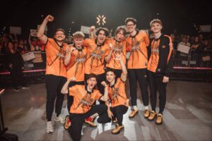 Fnatic VALORANT roster posing together and celebrating with fans after their Playoffs win