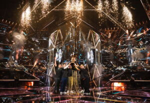 LOUD players raising the VALORANT Champions trophy on stage with fireworks and lights