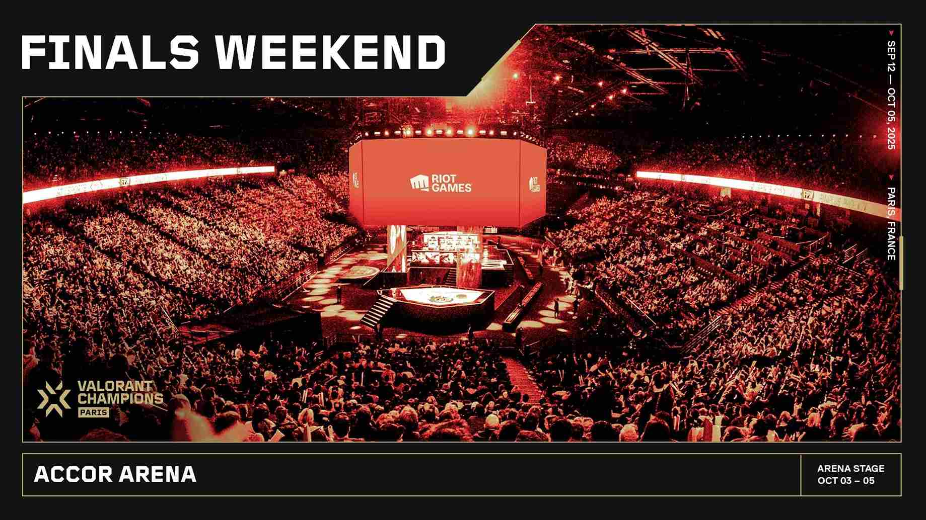 A packed arena at the Valorant Champions event with a large, illuminated 'Riot Games' screen. Excited crowd, vibrant red lighting, energetic atmosphere.