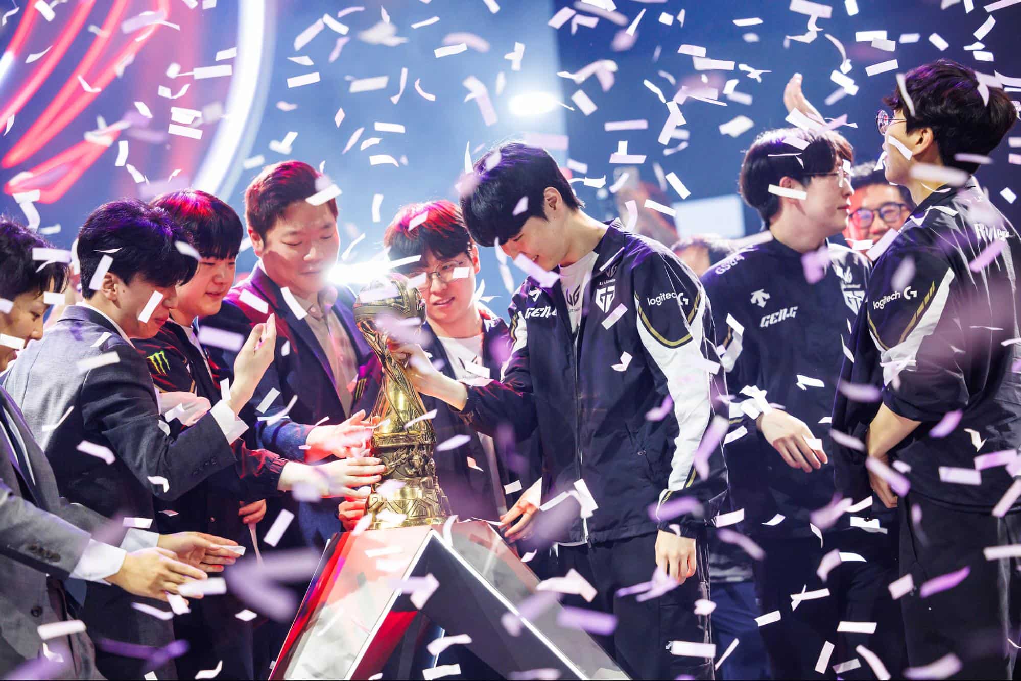 eam gathered around golden trophy with confetti falling on stage