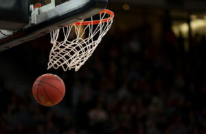 A Basketball going through a hoop