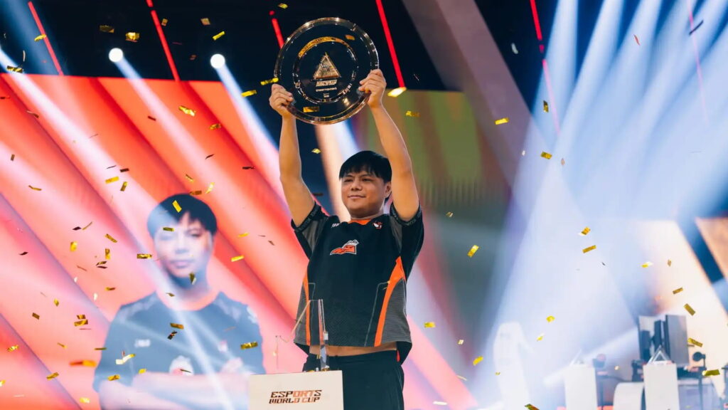 Esports World Cup player celebrates victory on stage