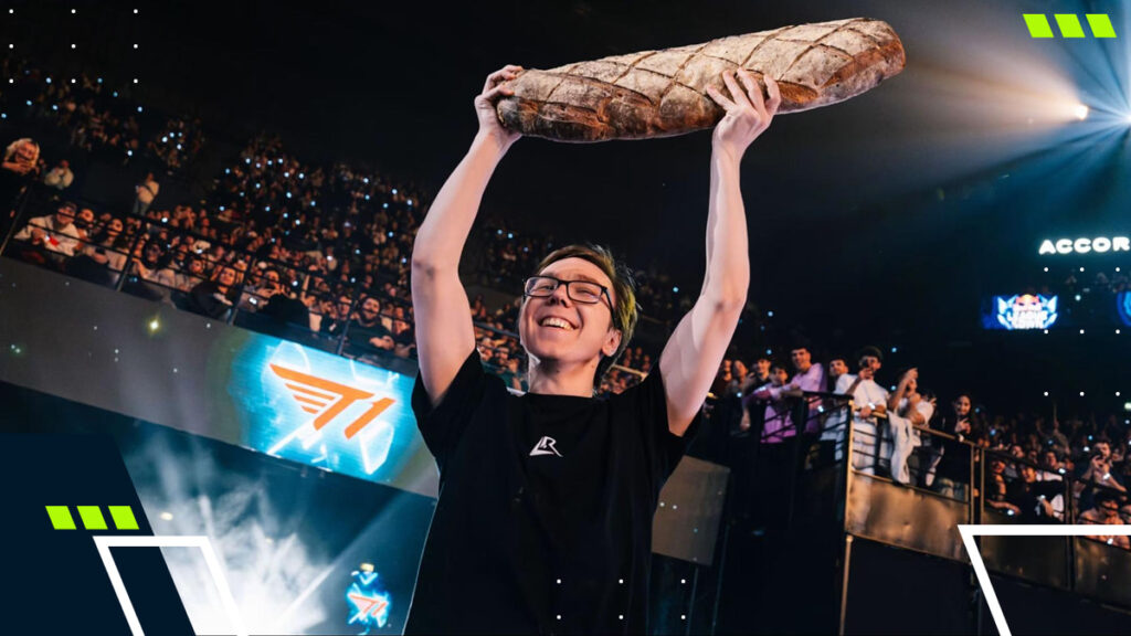 A League of Legends player celebrates on stage holding a large loaf of bread during a live event