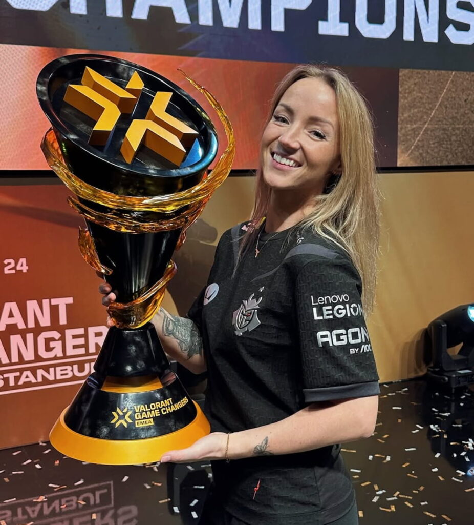 Petra Petra Stoker holding VALORANT Game Changers championship trophy on stage