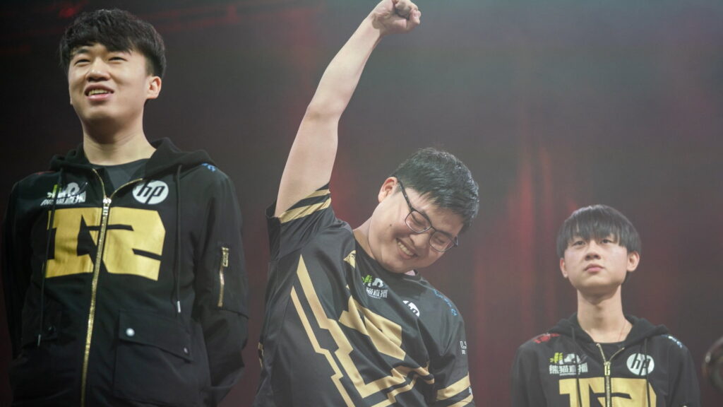 Royal Never Give Up players celebrating during League of Legends Worlds 2018 with Uzi raising his arm