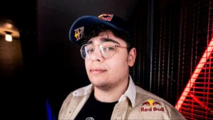 A person wearing a Red Bull–branded shirt and cap posing for a photo