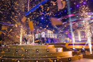 Team Falcons celebrate Dota 2 The International 2025 championship win on stage with confetti and lights