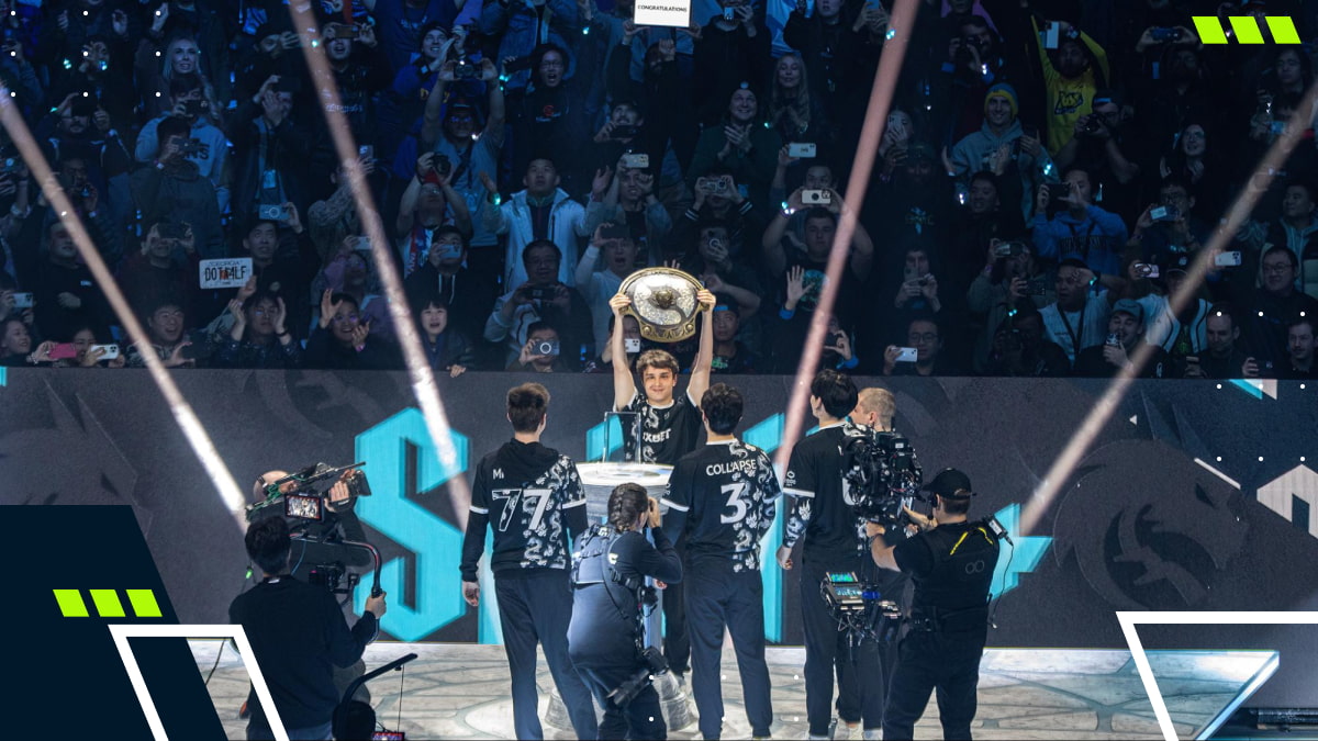 Team Spirit celebrates victory at The International Dota 2 tournament, lifting the Aegis trophy before the crowd