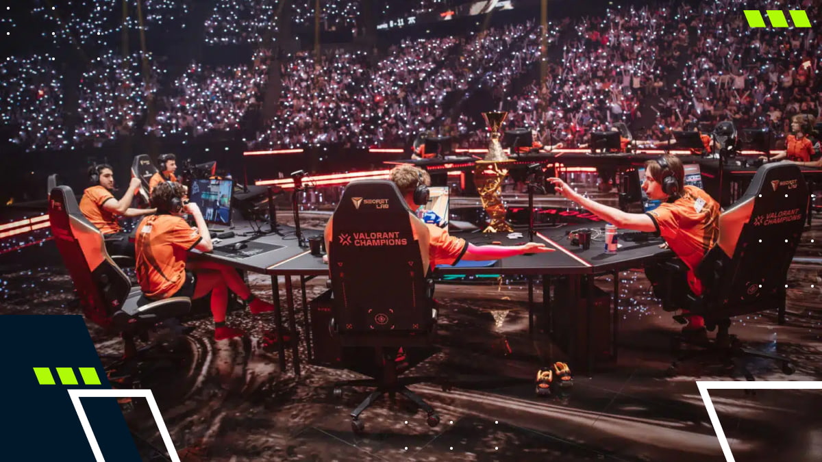 Players compete on stage during a live VALORANT Champions esports event in front of a large crowd