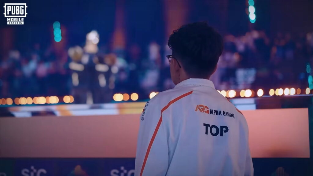 A PUBG Mobile esports player from Alpha Gaming watches the stage during a PUBG Mobile tournament