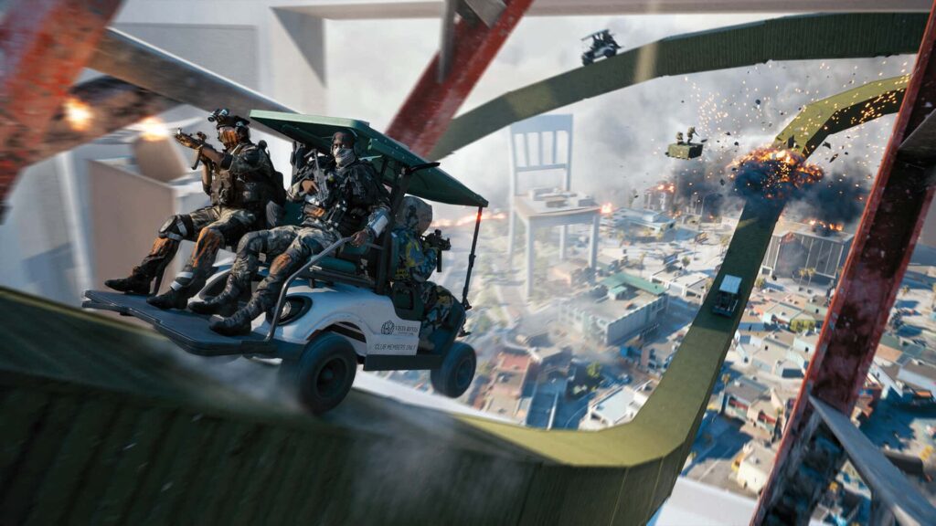 A squad of soldiers rides an armed vehicle down a steep track above a burning city as explosions erupt in the distance in Battlefield REDSEC.