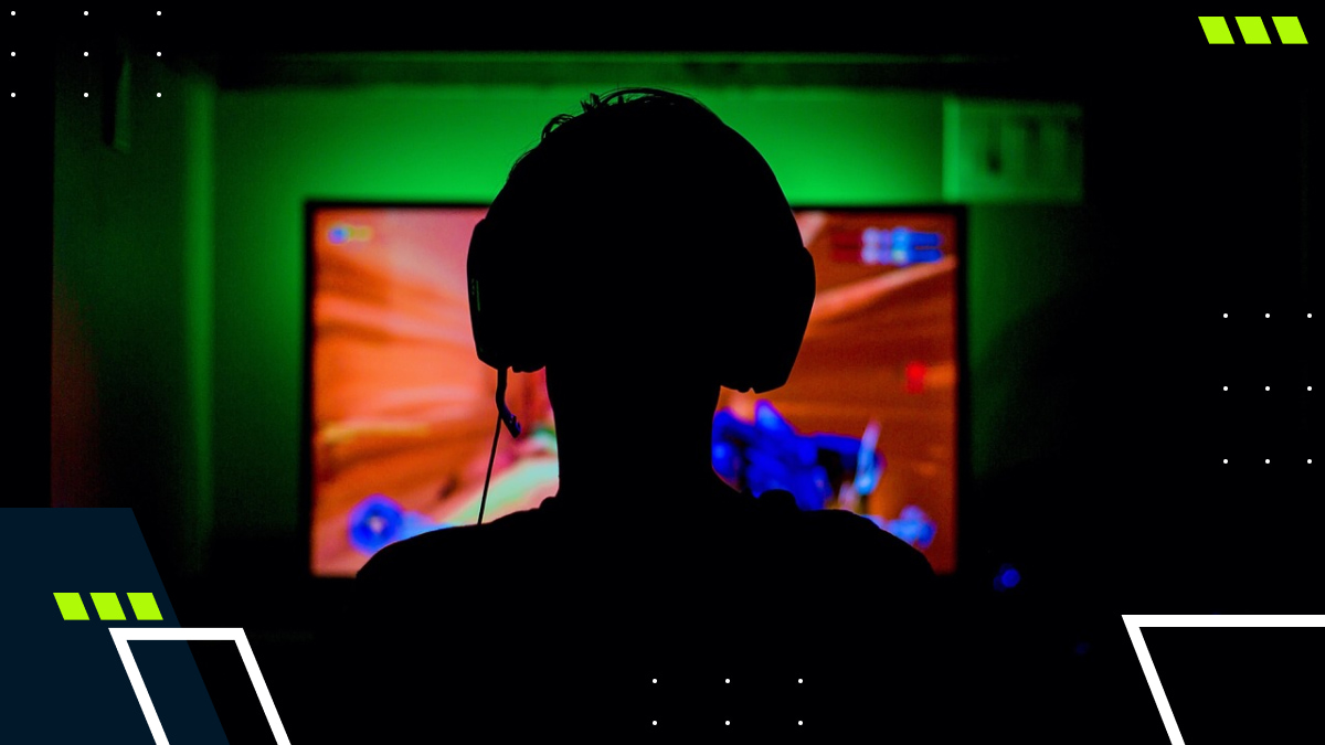 Gamer wearing headphones competes in an esports match on screen
