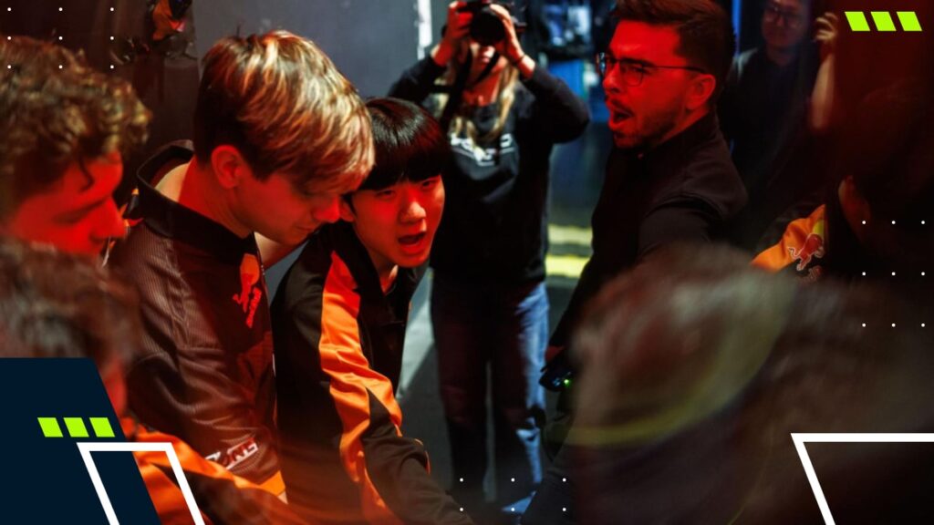 FNATIC players and staff gather in a team huddle backstage, showing unity and motivation before an esports match.