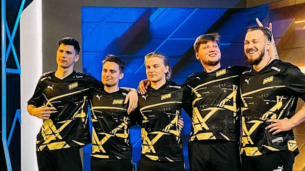 NAVI players standing together in a celebratory group pose