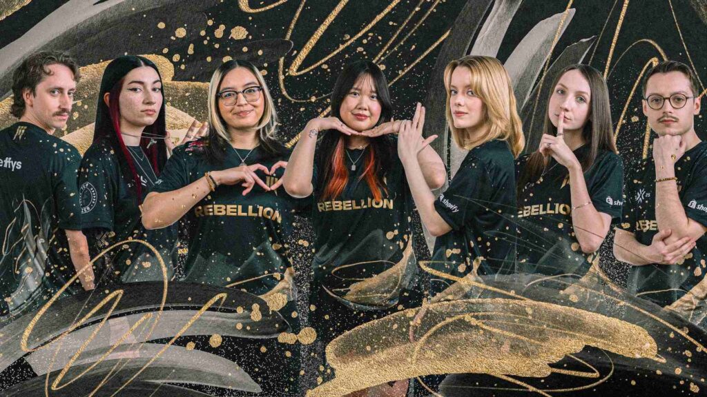 Shopify Rebellion Gold VALORANT team portrait featuring all players and coach wearing black Rebellion jerseys with gold accents.