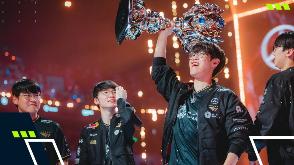 Esports players celebrating on stage as one teammate lifts a League of Legends championship trophy