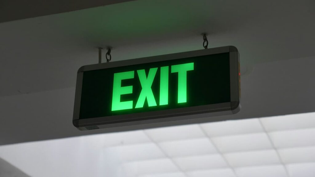 Exit sign hanging from a ceiling