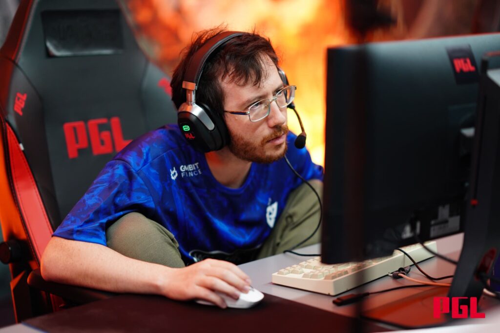 A professional player concentrating during a high-pressure Dota 2 match on stage