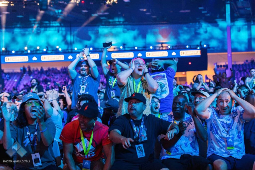 Fans react emotionally inside a packed arena during a major esports tournament