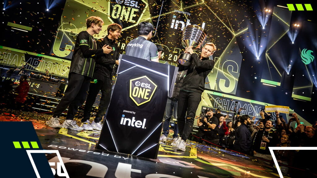 An esports team celebrates onstage at an ESL One event as confetti falls