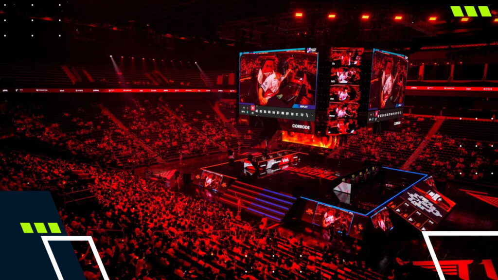 Large-scale esports tournament held in a packed indoor arena with a main stage and giant screens