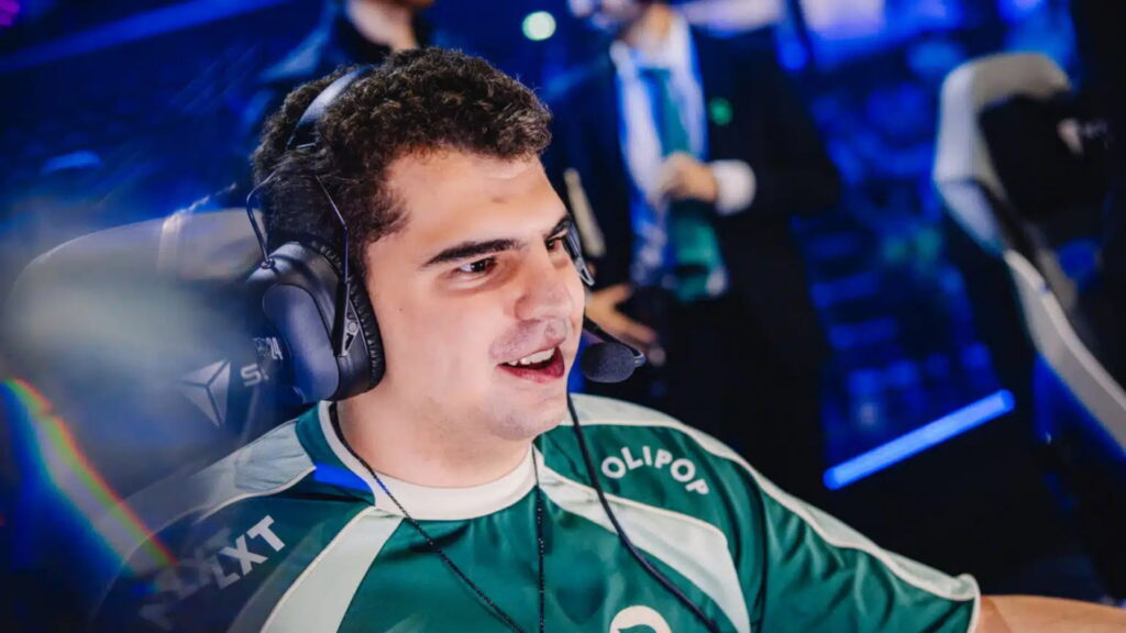 Esports player smiling while wearing a headset on stage
