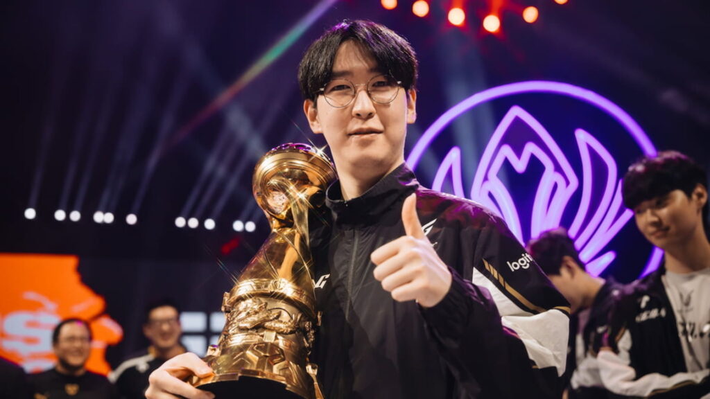 League of Legends support player celebrating a Worlds victory while holding the championship trophy