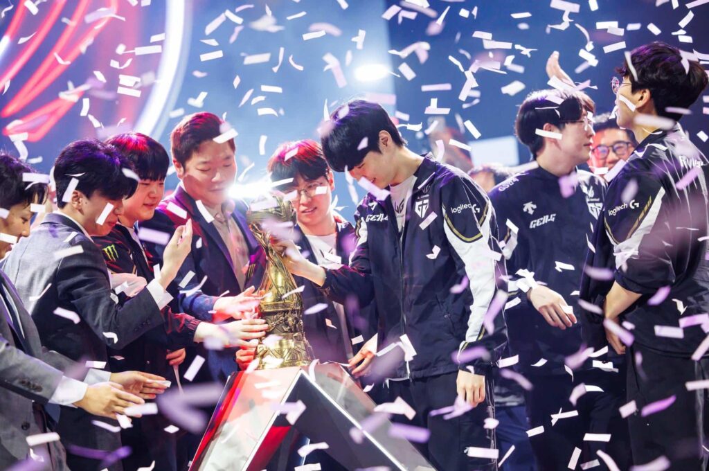 Gen.G players gather around the MSI 2025 trophy on stage after their League of Legends win