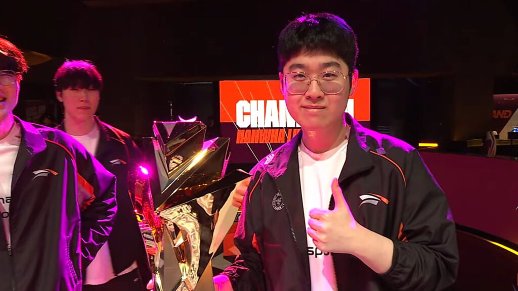 Player posing with a championship trophy during an esports event
