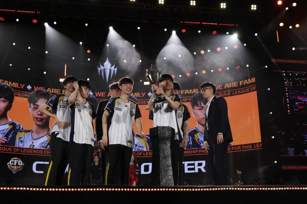 The winning team lifts the trophy onstage during a League of Legends Championship Pacific event