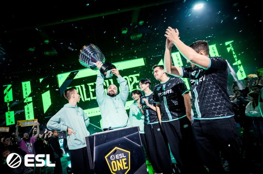 PARIVISION players celebrate on stage as they lift the ESL One trophy after a Dota 2 victory