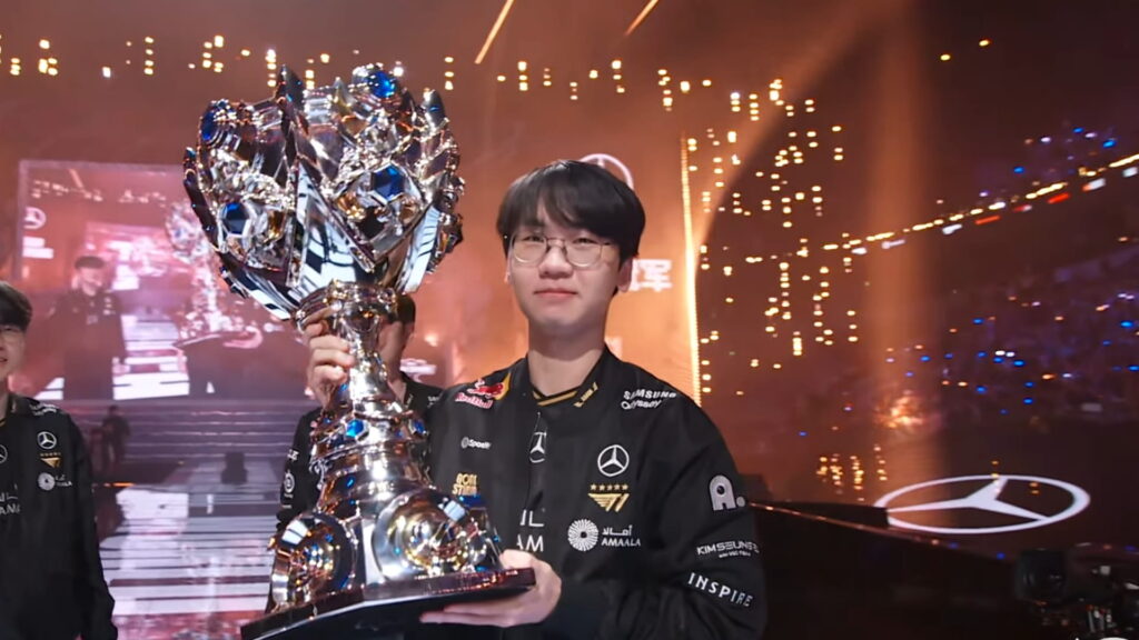 Player holding the championship trophy on a League of Legends Worlds stage
