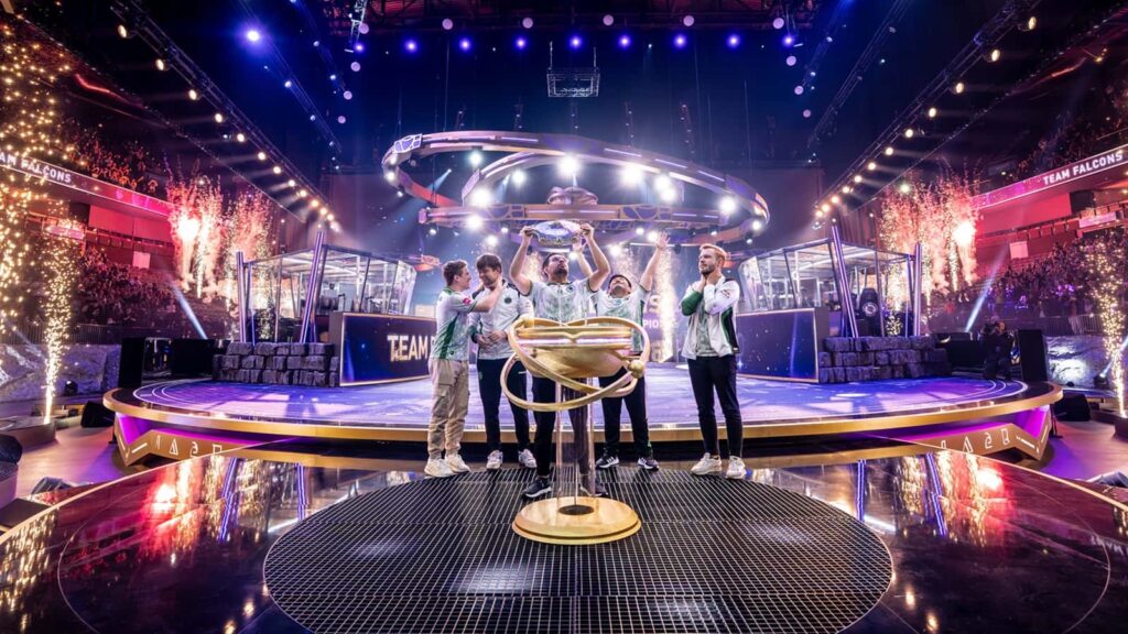 Team Falcons celebrates on stage holding the Aegis trophy after winning Dota 2’s The International