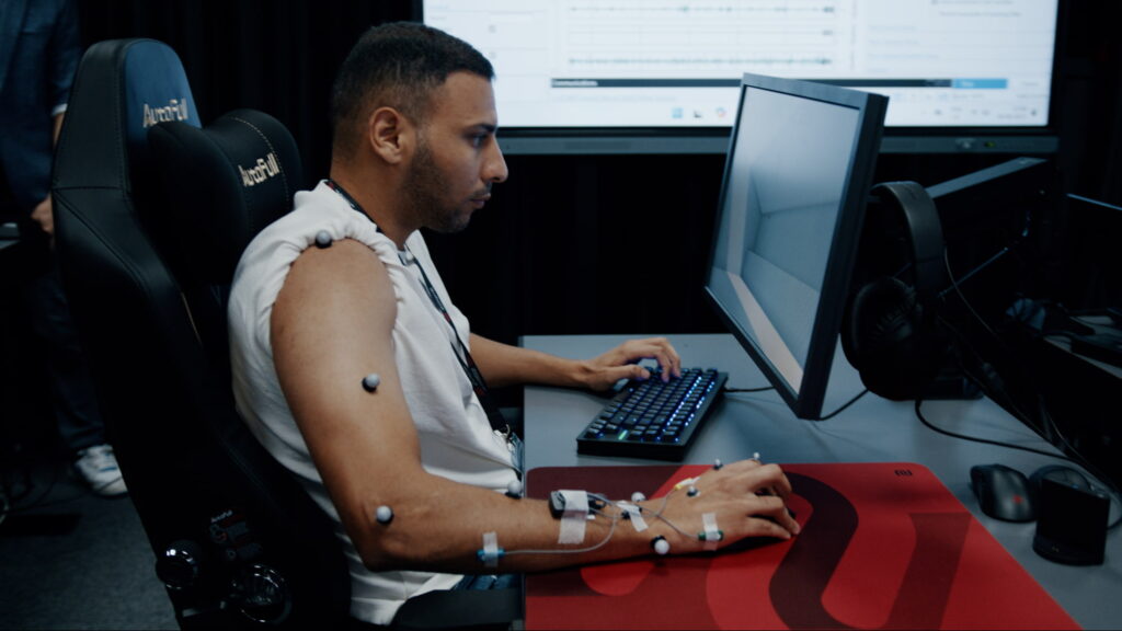 A player undergoing esports performance testing at ZOWIE’s Sports Science Lab, wearing motion-capture markers and sensors while using a mouse and keyboard to analyze precision, fatigue, and consistency under controlled conditions