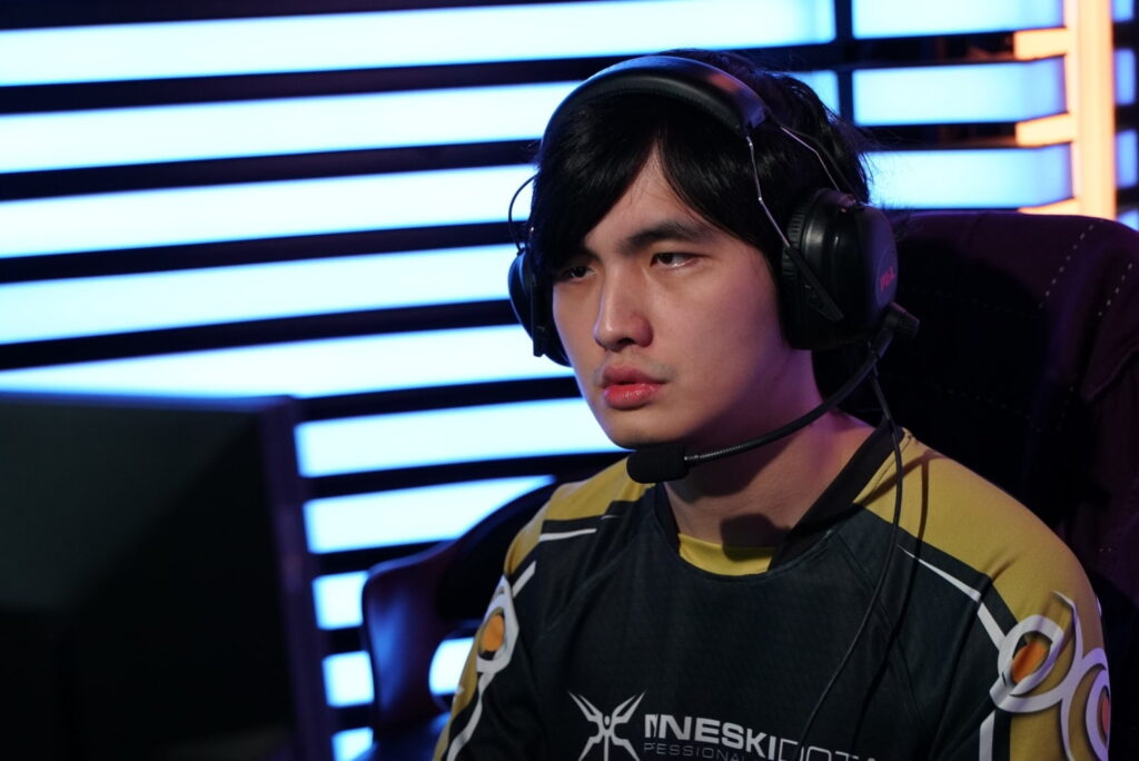 A professional player concentrating during a tense Dota 2 match on stage