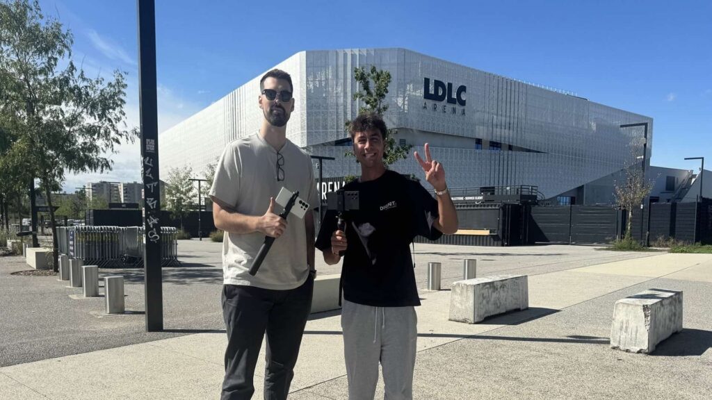 Aussie Antics and content creator posing with recording gear outside LDLC Arena in Lyon