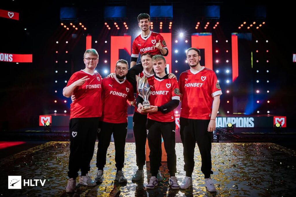 Counter-Strike 2 team celebrating on stage with the PGL trophy after a tournament win
