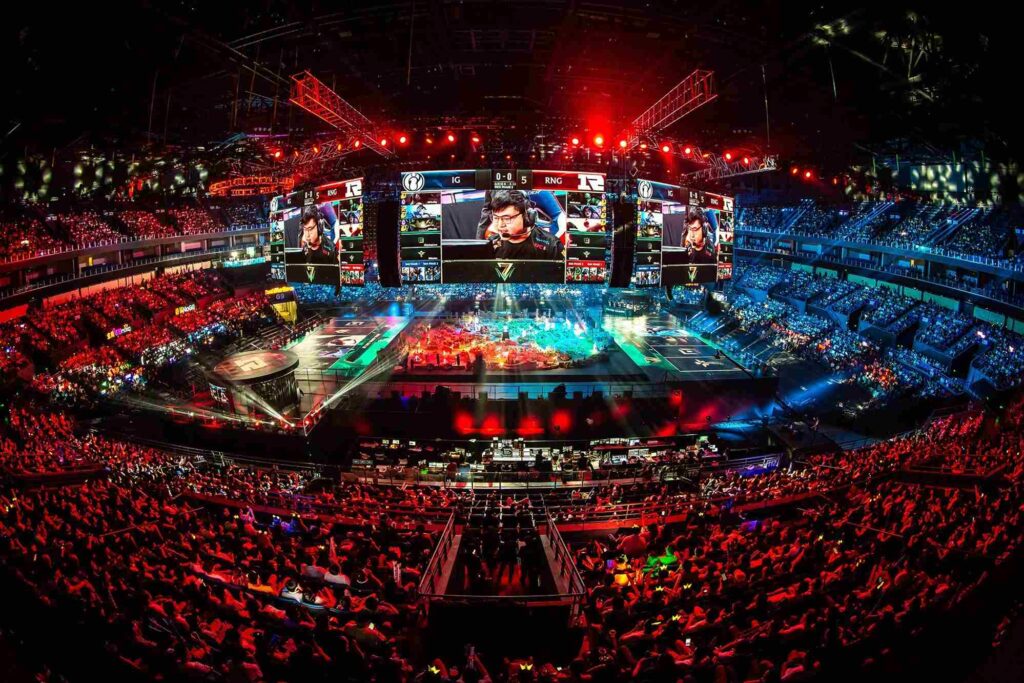 Packed esports arena during an LPL match showing Invictus Gaming (IG) vs Royal Never Give Up (RNG) on the main stage screens, illustrating the scale and format of LPL 2026 Split 1 League of Legends competition.