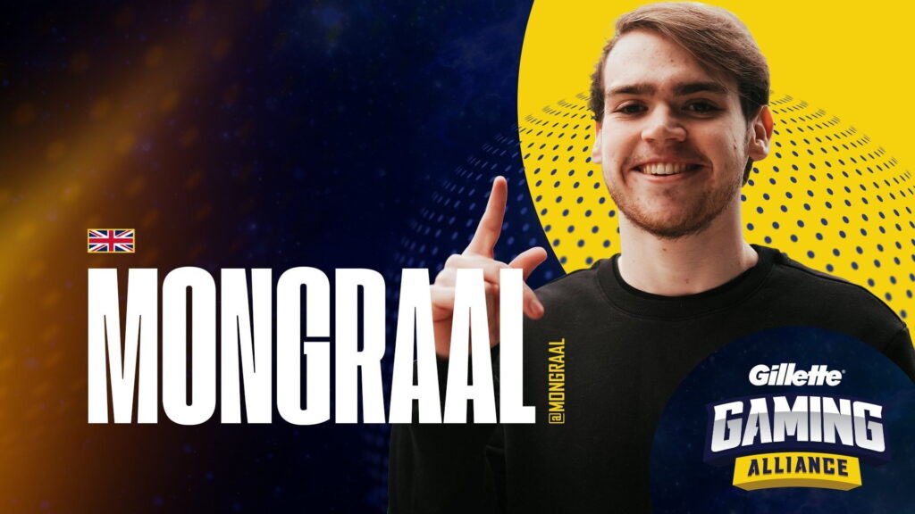 Mongraal, professional Fortnite player and streamer, smiling and pointing upward while wearing a Gaming Alliance sweatshirt