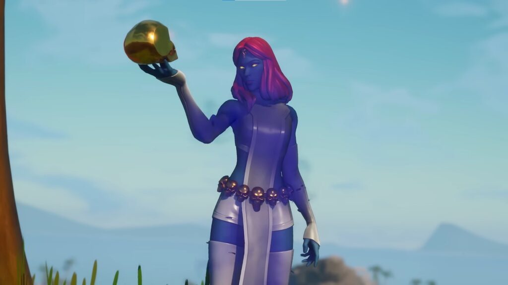 Marvel character Mystique holding a golden skull under a clear sky