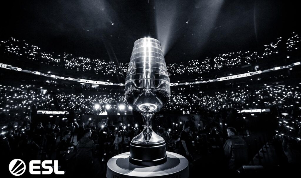 CS2 championship trophy displayed in a dark arena filled with spectators’ lights, symbolizing top-tier Counter-Strike 2 tournaments in 2026.