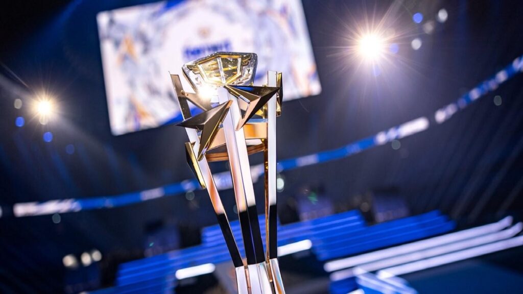 Close-up of the Fortnite FNCS championship trophy standing on a brightly lit esports stage